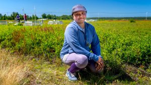 A photo of Rafa Tasnim in a blueberry field